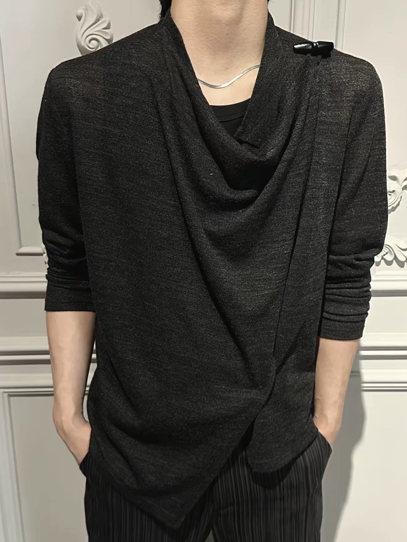 Black draped knit top on model