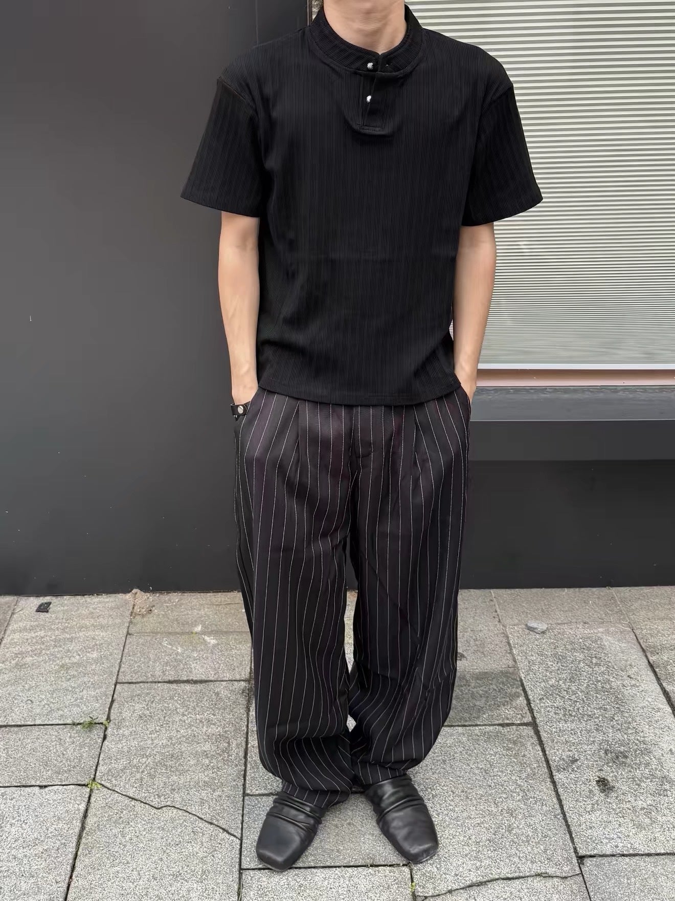 Black ribbed henley tee on model